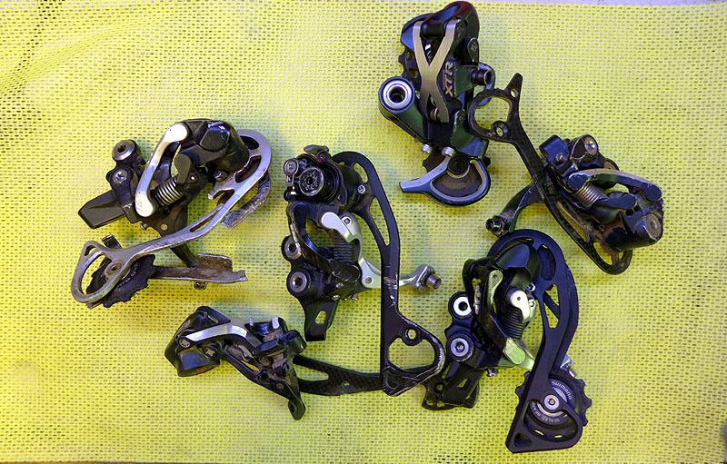 Picture of various Shimano 9 and 10 speed derailleurs in normal, shadow and shadow+ versions