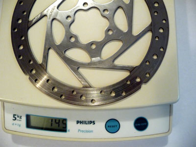 Picture of Shimano 160mm SM-RT51 disc brake rotor on scale weighing 145g